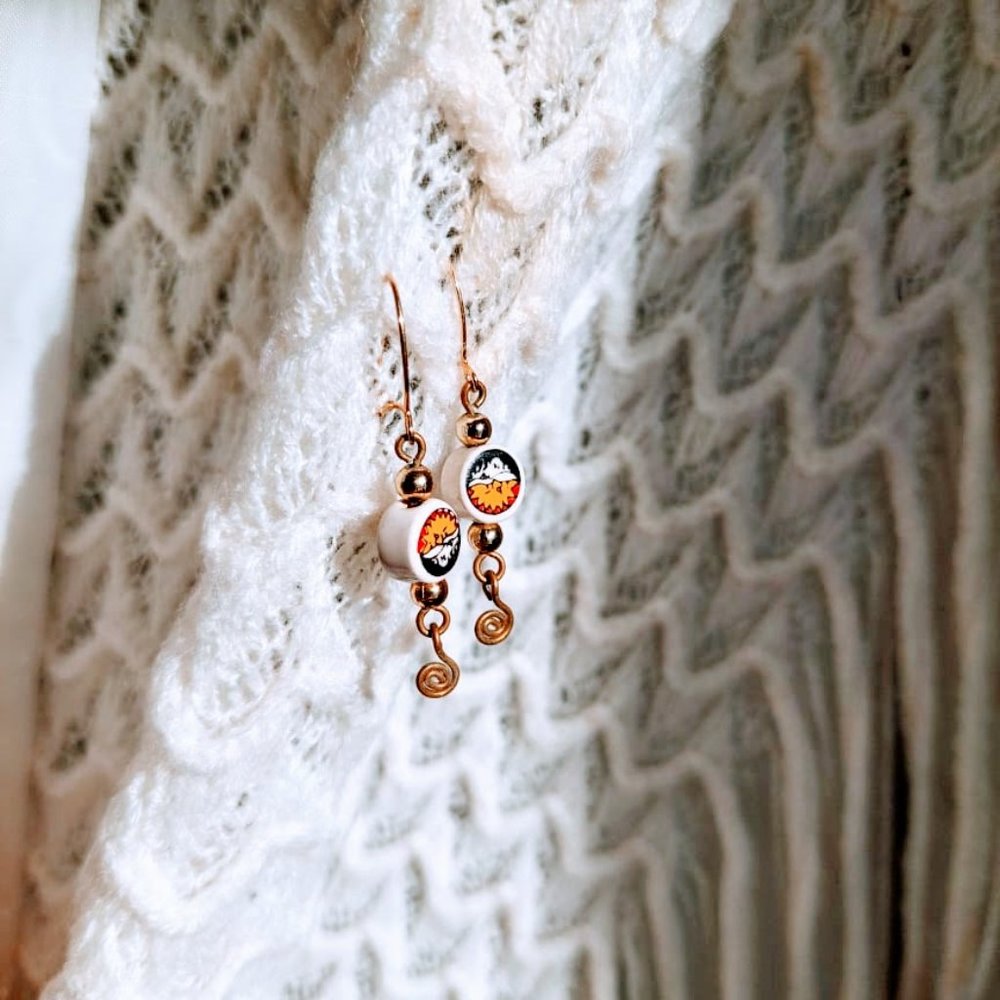 Gold drop earrings with sun motif